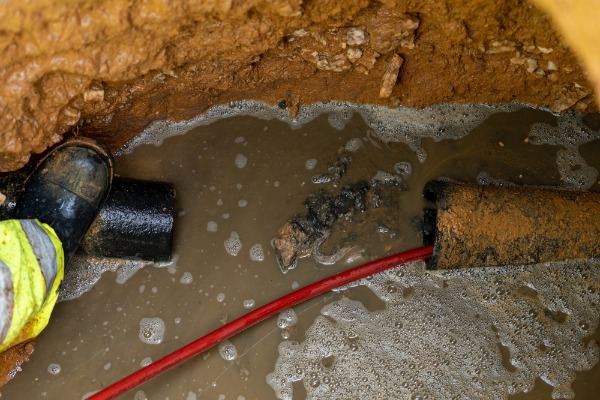 damaged underground pipe leaking muddy water